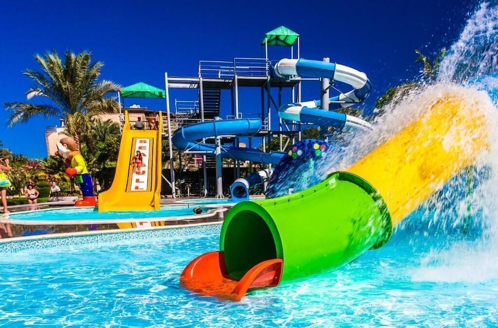 Seagull Beach Resort Hurghada pool area with blue spiral slides and a green enclosed flume.