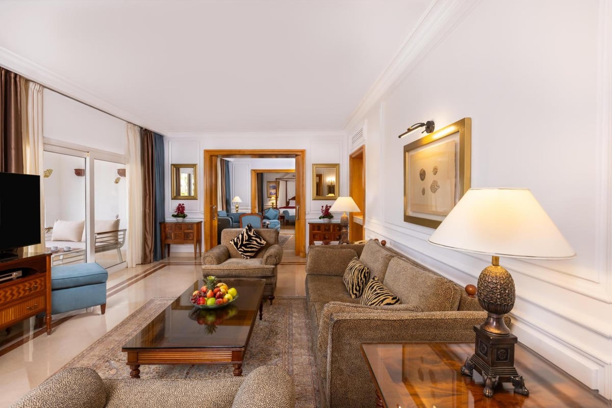 Savoy Sharm El Sheikh sitting room with patterned sofas and framed artwork.