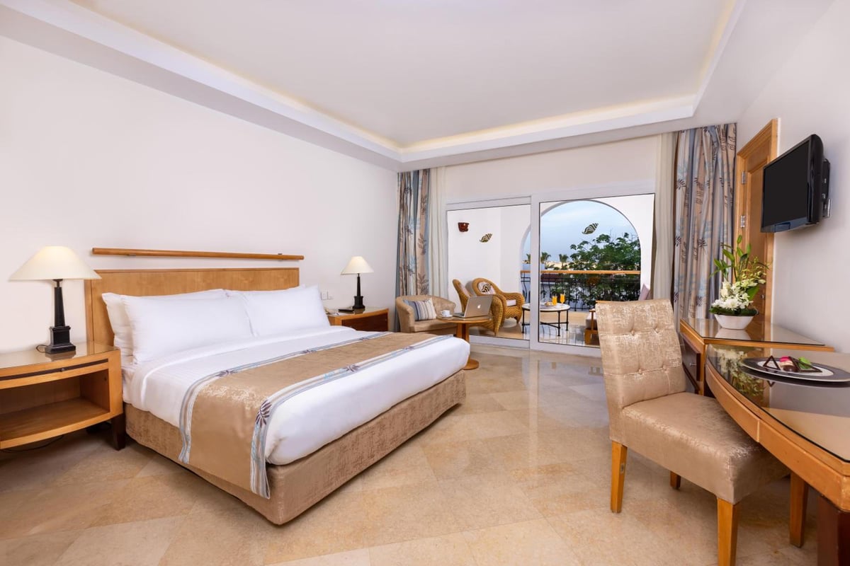 Savoy Sharm El Sheikh guest bedroom with a double bed and balcony doors.
