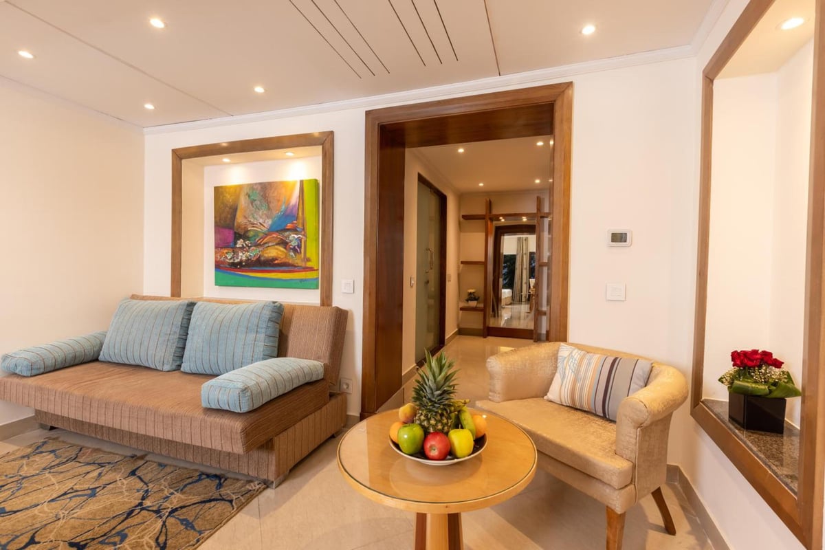 Savoy Sharm El Sheikh sitting area with two sofas and framed artwork.