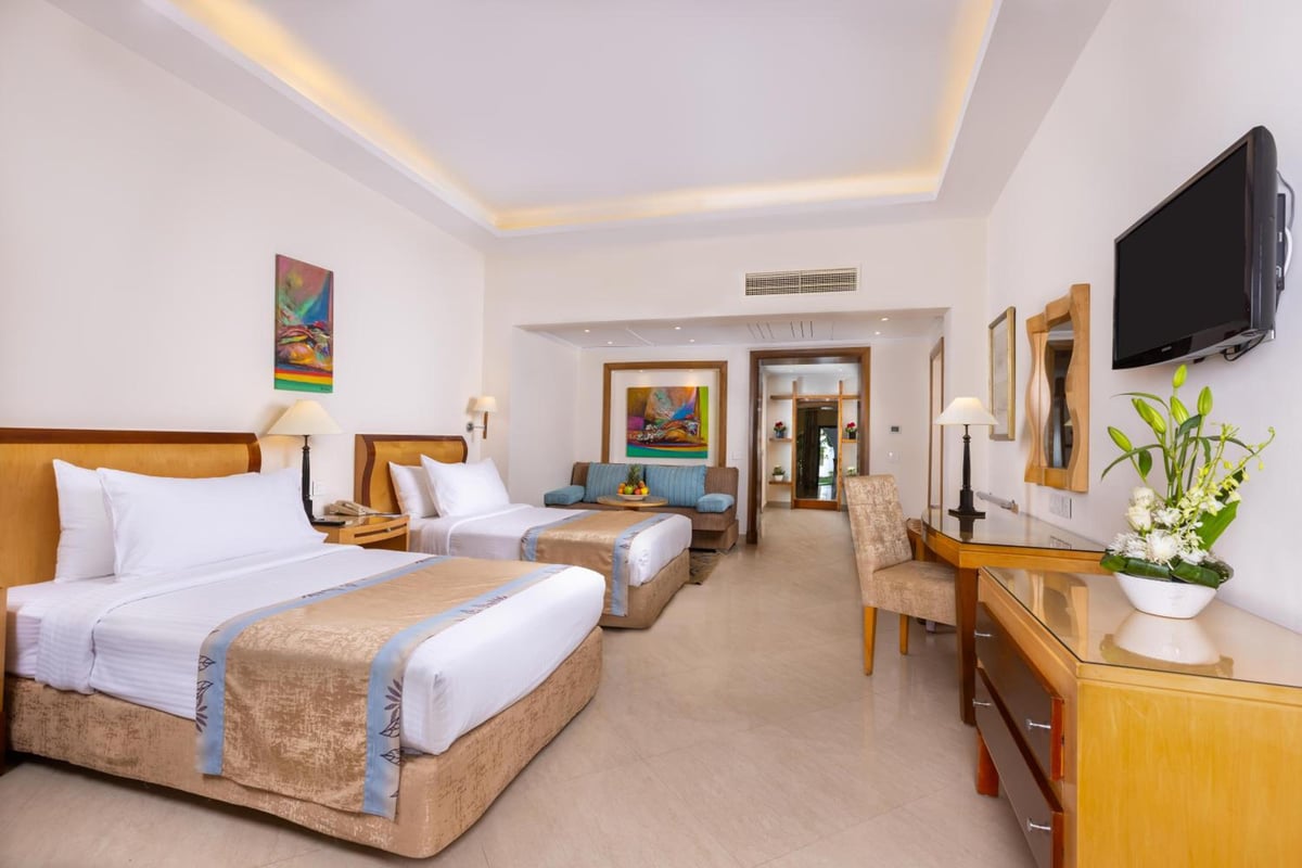 Savoy Sharm El Sheikh twin room with two beds and a sitting area.