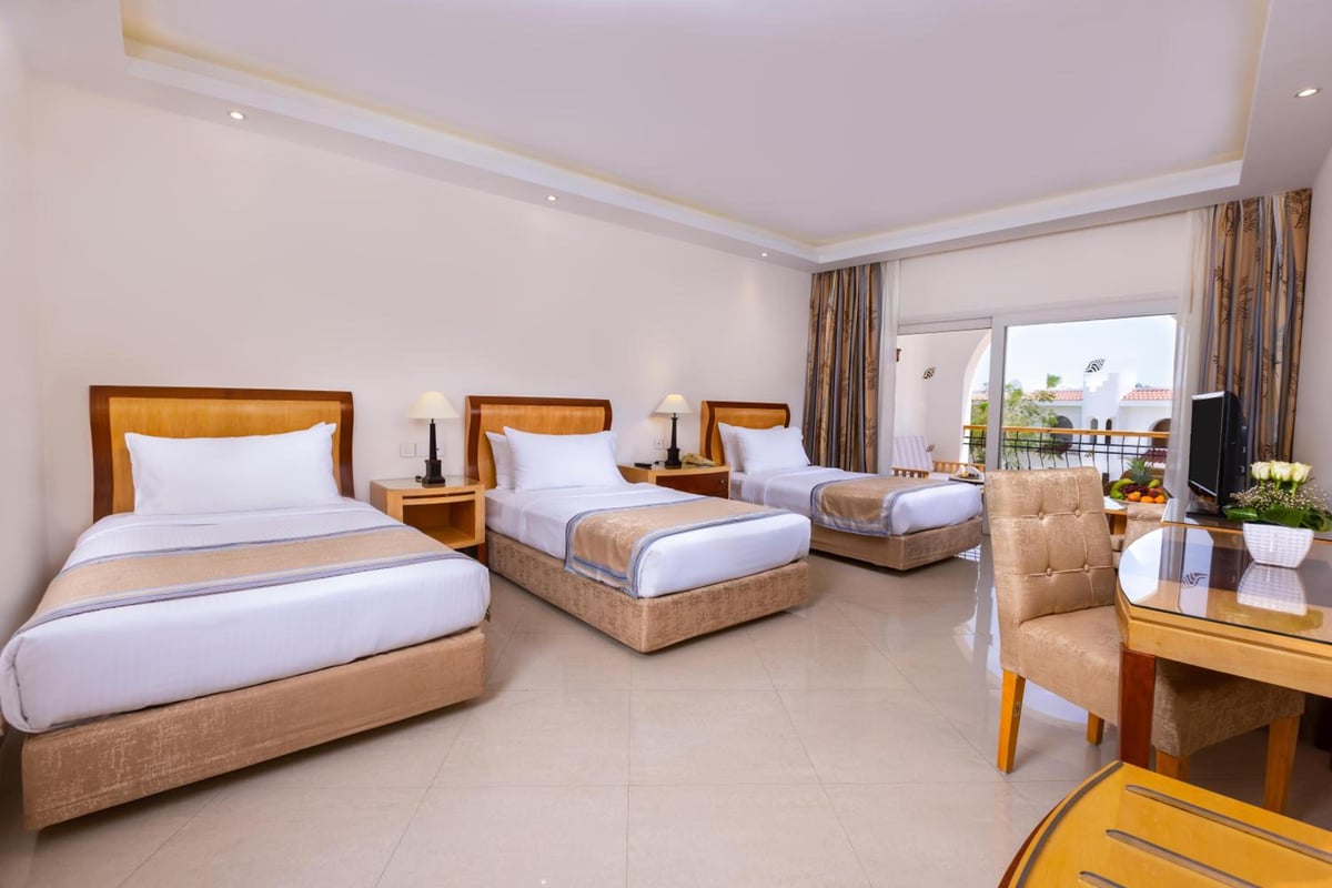 Savoy Sharm El Sheikh guest room with three beds and a balcony.