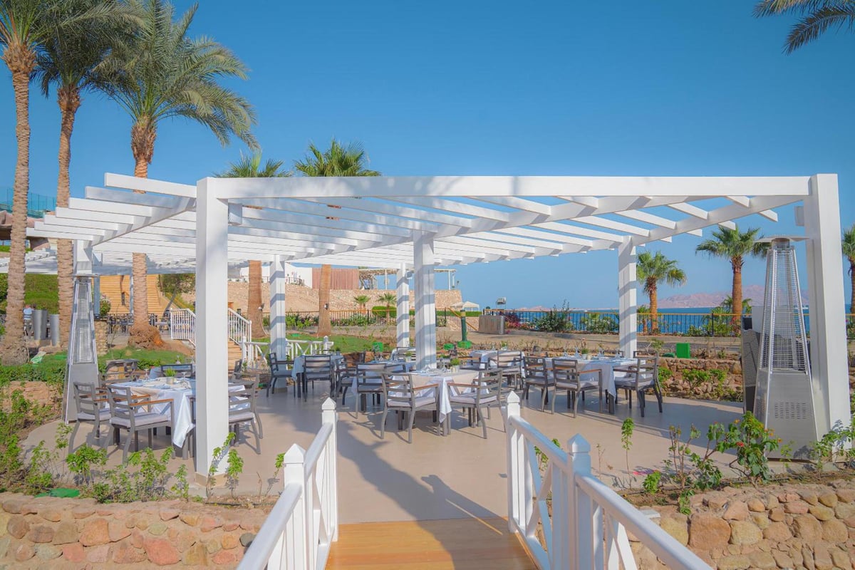 Savoy Sharm El Sheikh outdoor dining terrace with a white pergola and sea views.