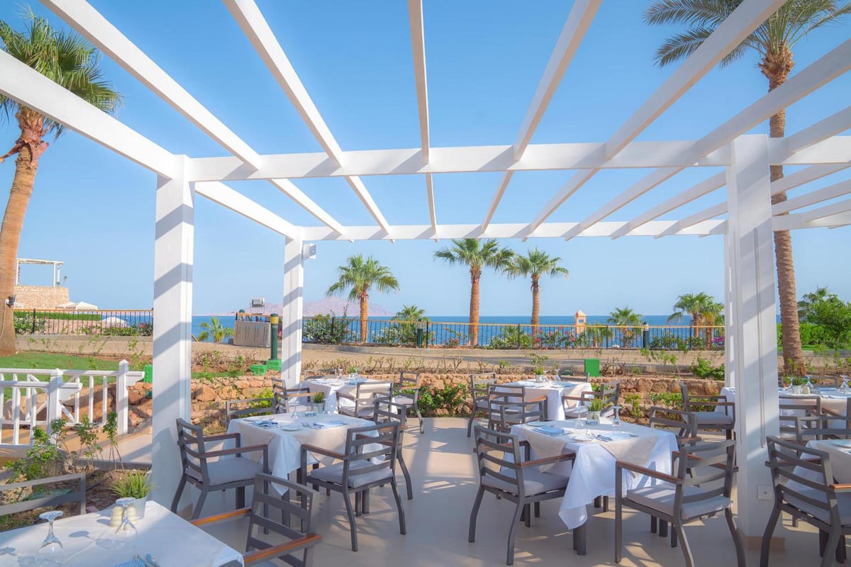 Savoy Sharm El Sheikh dining terrace with a white pergola and sea view.