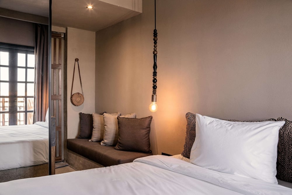 Cook's Club El Gouna (Adults Only) guest room with a bed and sofa.