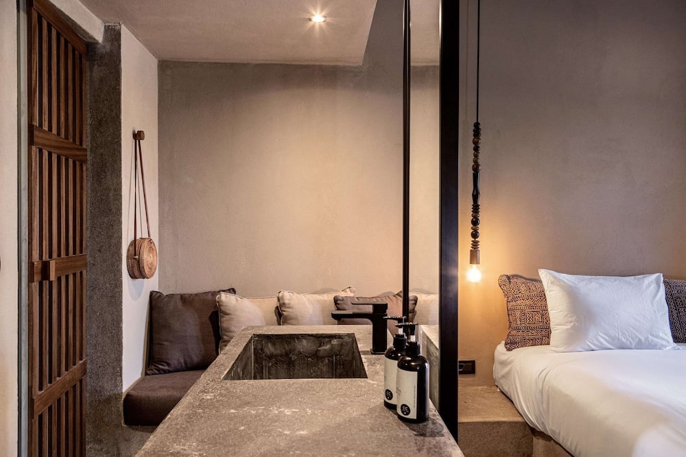 Cook's Club El Gouna guest room with a bed and sitting area.