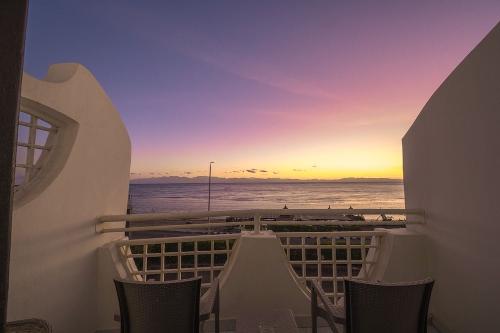 The Bedouin Moon Hotel Dahab balcony with a sea view and sunset sky.
