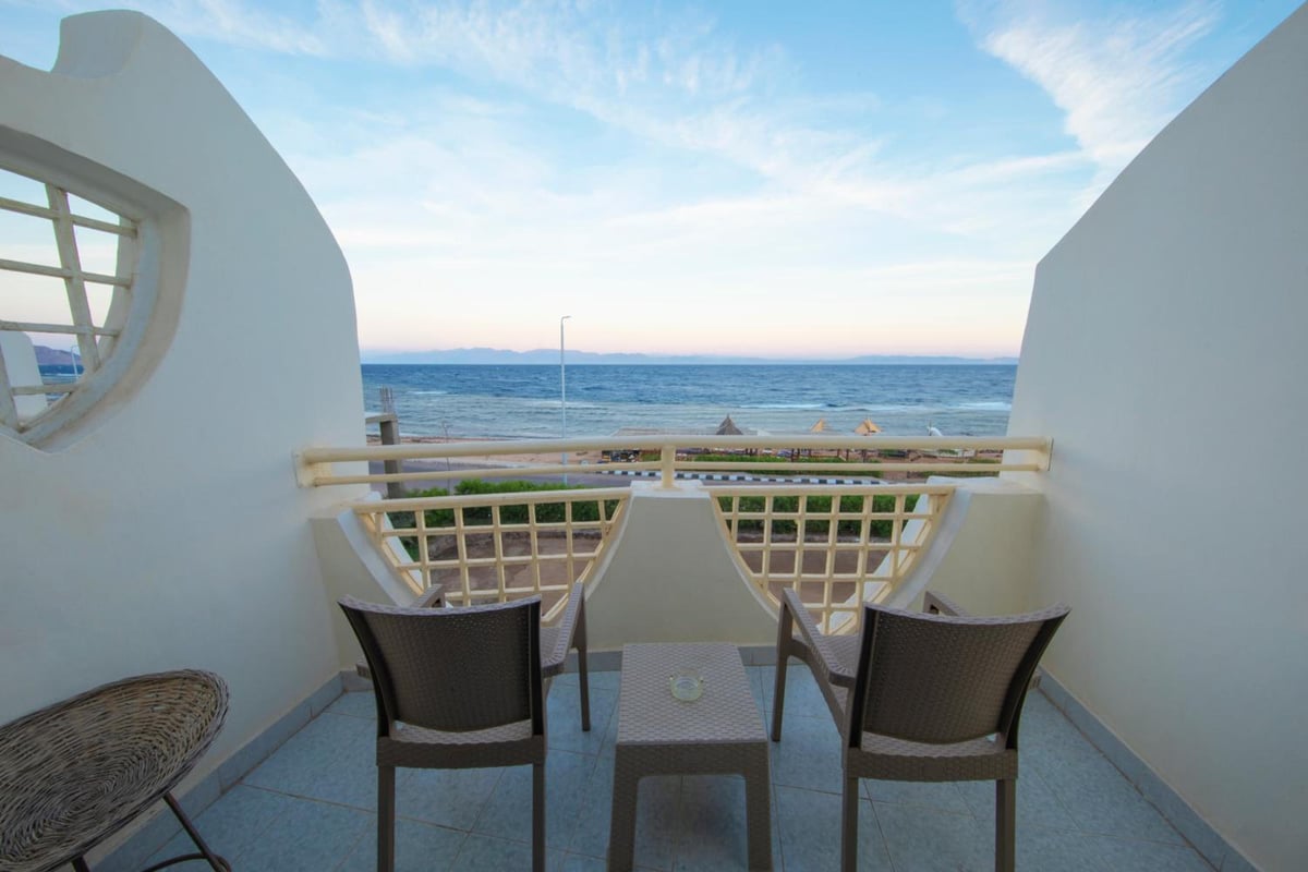 The Bedouin Moon Hotel Dahab balcony with a sea view and curved white walls.