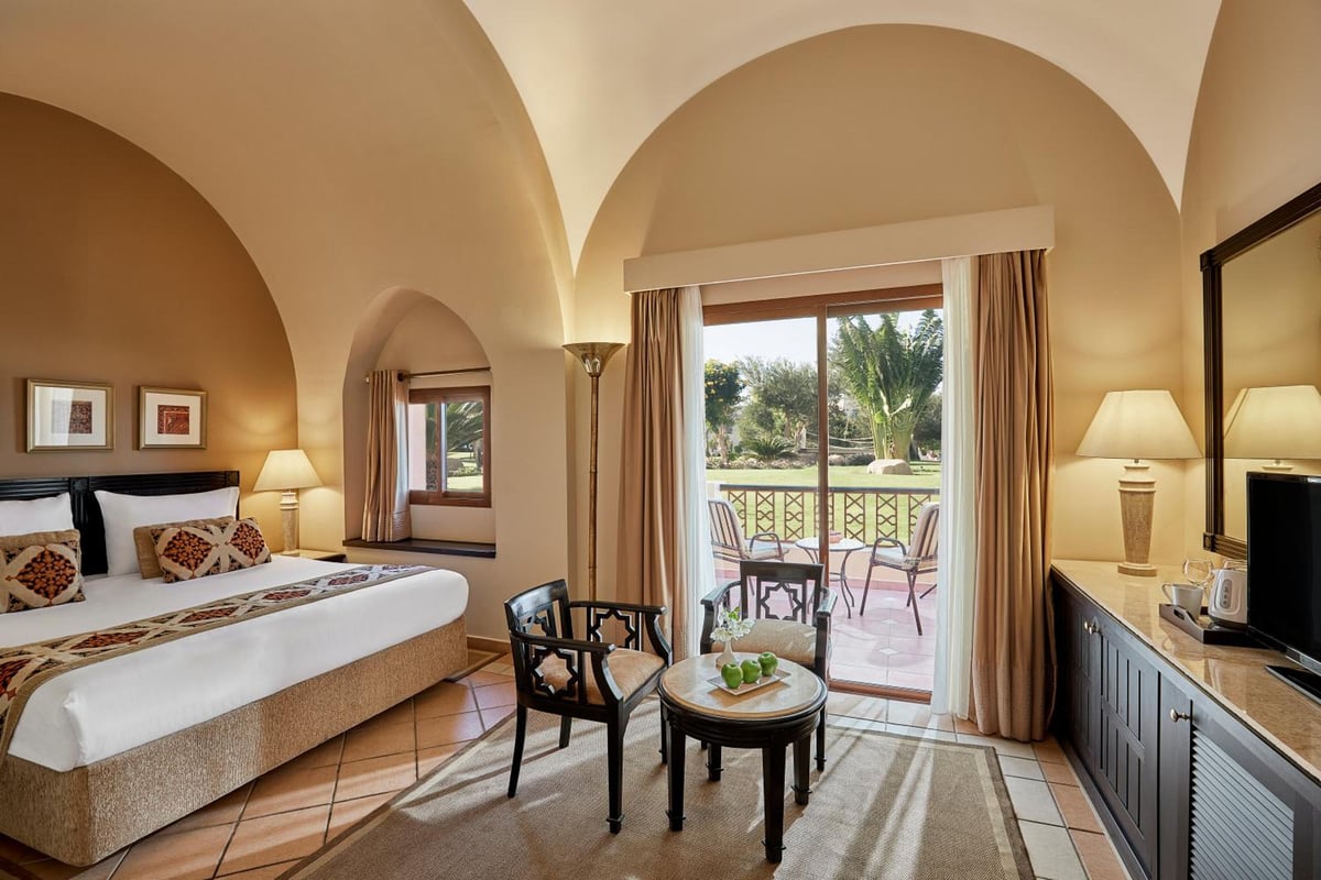 Steigenberger Coraya Beach (Adults Friendly 16+) guest room with an arched ceiling and patio doors.
