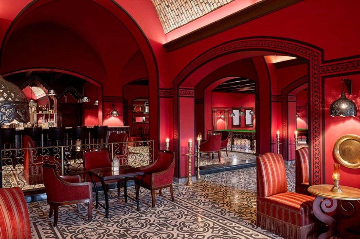 Steigenberger Coraya Beach (Adults Friendly 16+) lounge with red arches and patterned floor.