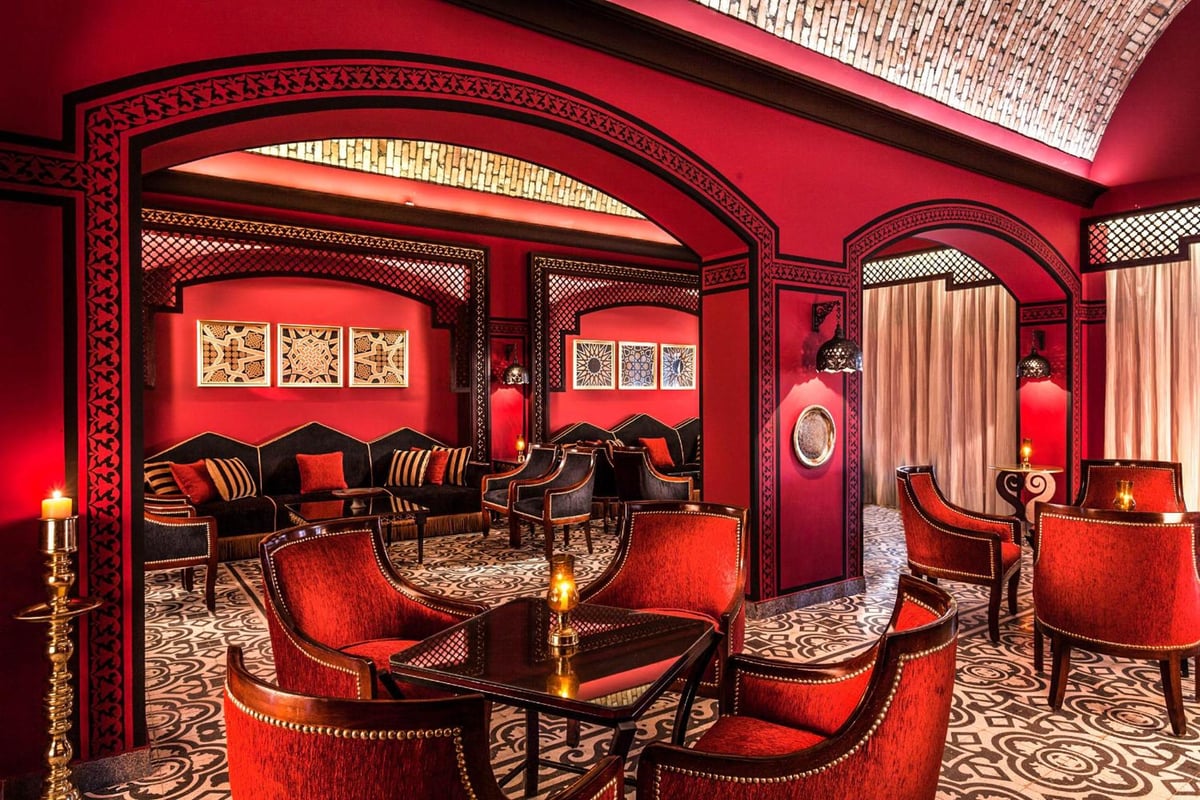 Steigenberger Coraya Beach (Adults Friendly 16+) lounge with red walls and patterned flooring.