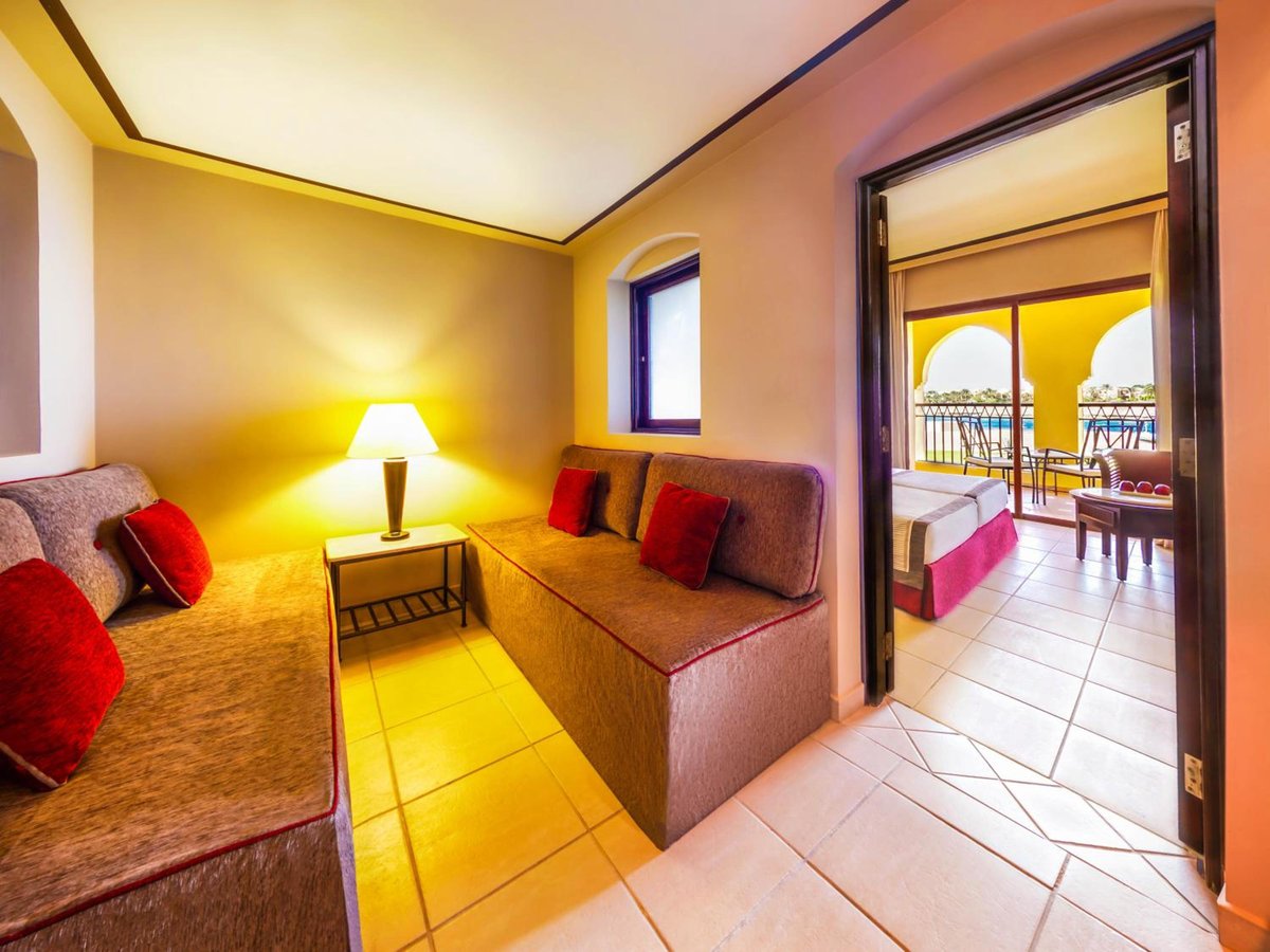 JAZ Lamaya Resort sitting area with upholstered benches and tiled flooring.