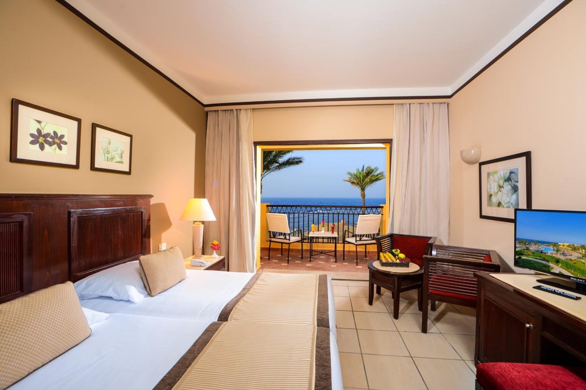 JAZ Lamaya Resort guest room with twin beds and a sea-view balcony.