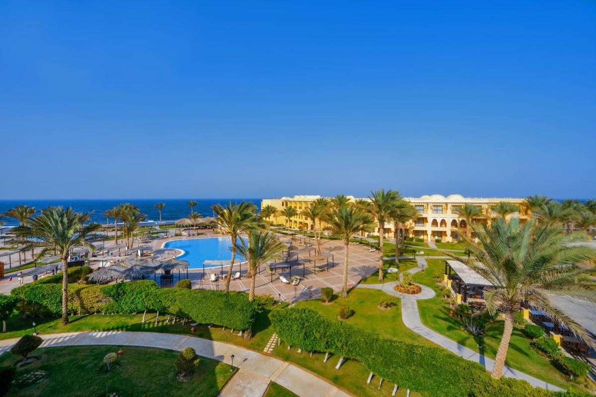 JAZ Lamaya Resort grounds with a swimming pool and landscaped gardens.