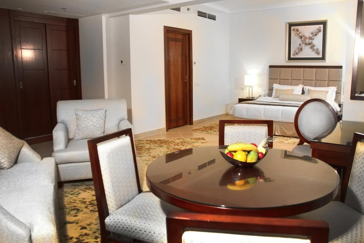 Tolip Hotel Alexandria guest room with a bed and a seating area.