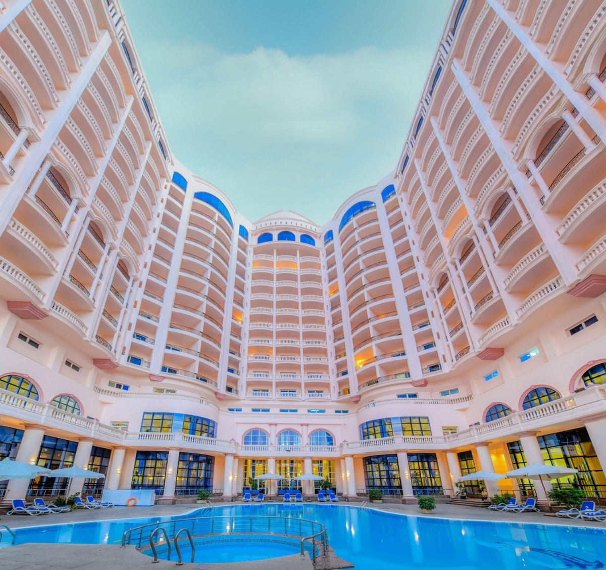 Tolip Hotel Alexandria courtyard pool with blue water and curved balconies.