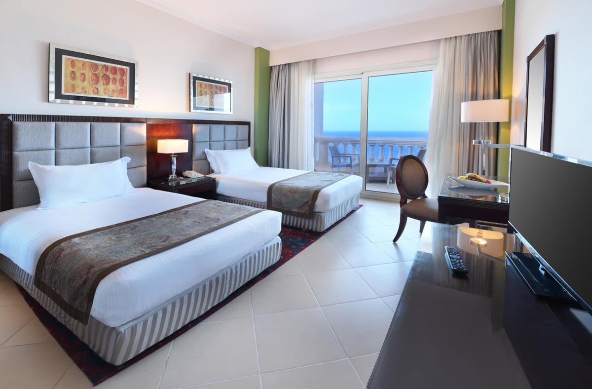 Tolip Hotel Alexandria twin room with two beds and sea views.