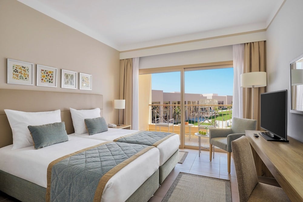 JAZ Elite Maraya twin bedroom with twin beds and a balcony.