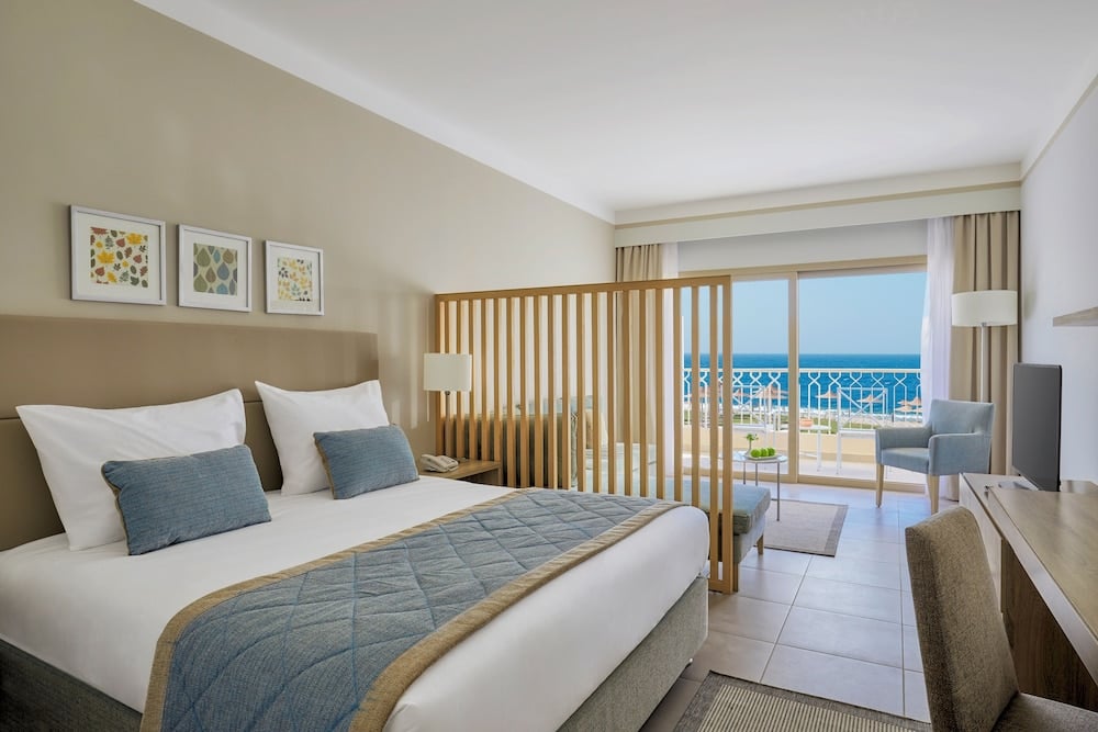 JAZ Elite Maraya bedroom with a wooden slat partition and balcony.
