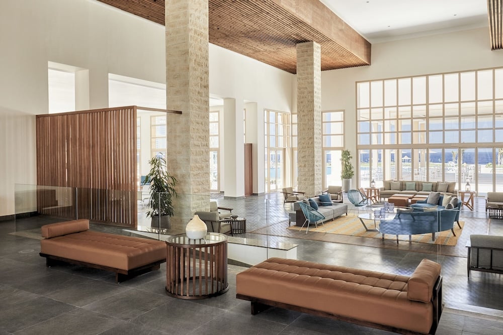 JAZ Elite Maraya lobby with lounge seating and tall windows.