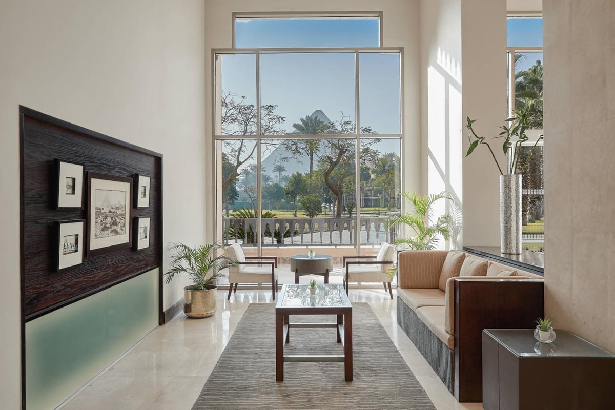 Marriott Mena House Cairo lounge with floor-to-ceiling window and sofas.