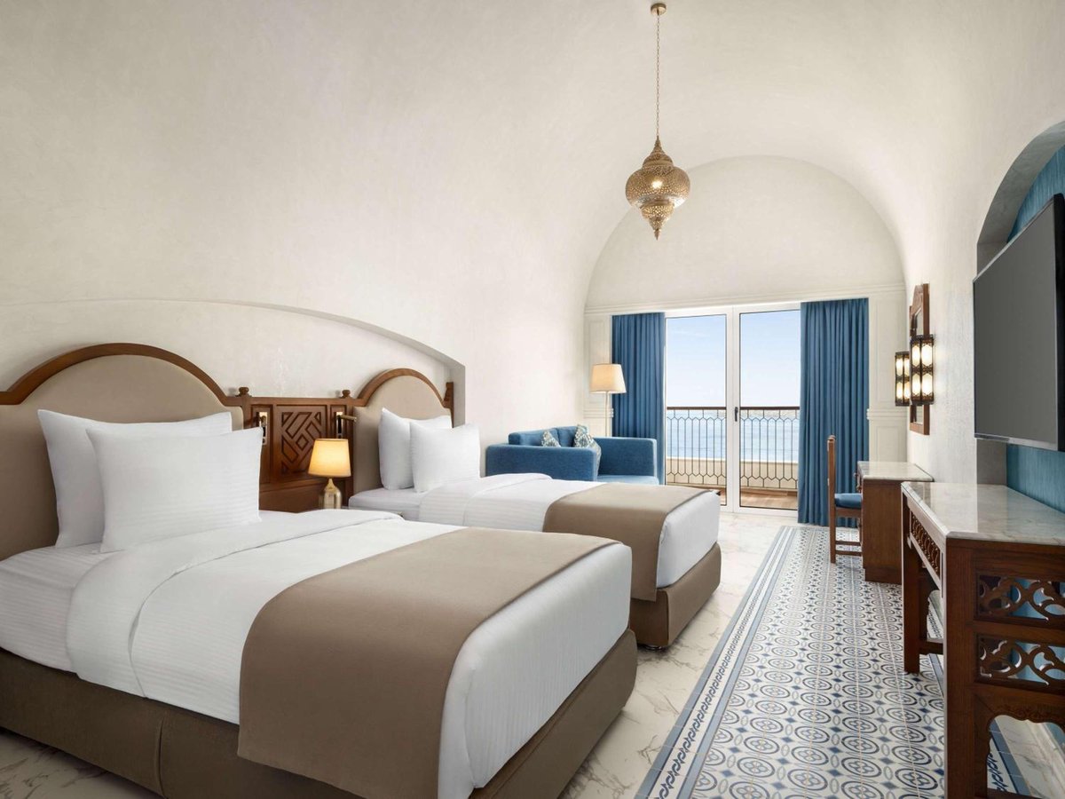 Movenpick Resort Sharm El Sheikh twin bedroom with two beds and an arched ceiling.