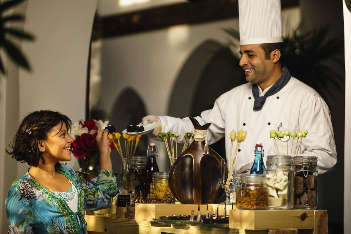 Movenpick Resort Sharm El Sheikh restaurant with a chef serving food and a guest at the counter.