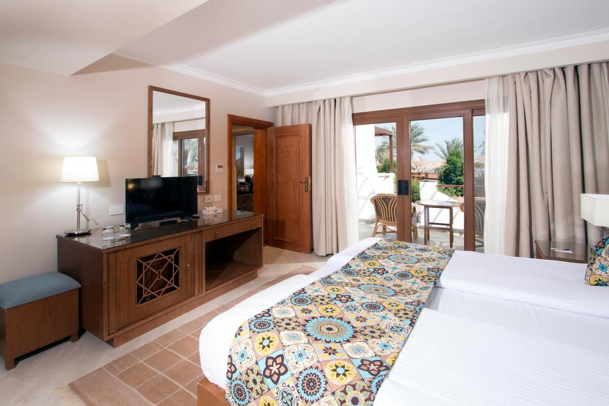 Swiss Inn Resort Dahab guest room with twin beds and balcony doors.