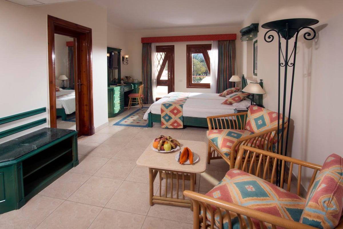Swiss Inn Resort Dahab guest room with a bed and a sitting area.
