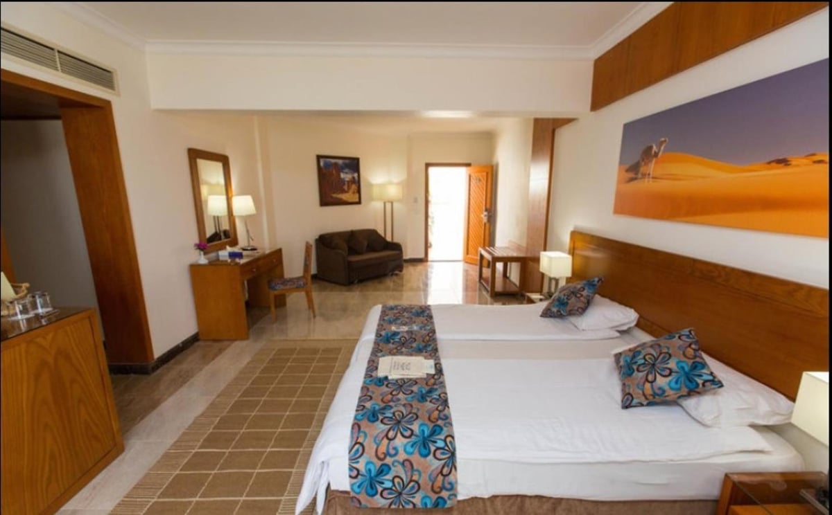 Swiss Inn Resort Dahab twin room with two beds and a sitting area.
