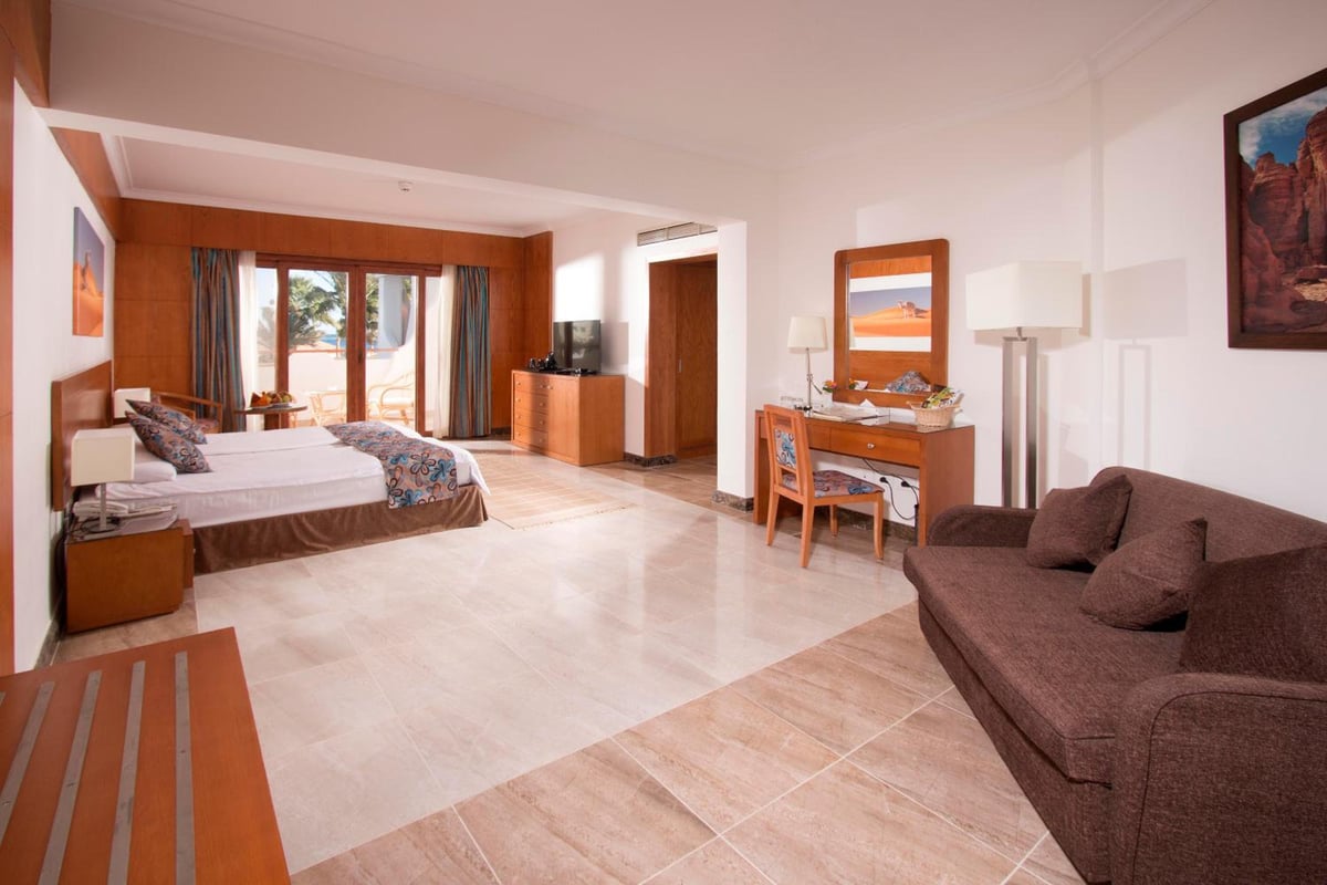 Swiss Inn Resort Dahab guest room with a bed and sofa.