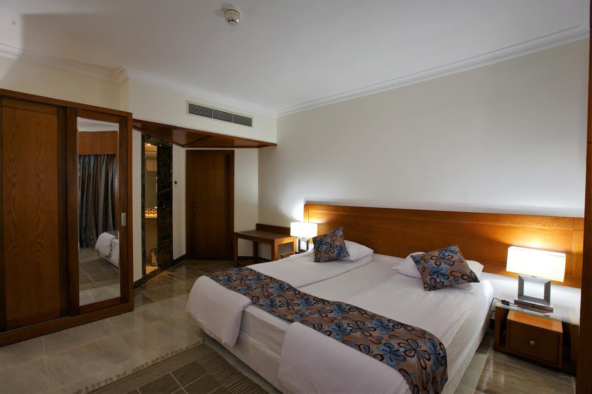 Swiss Inn Resort Dahab guest room with twin beds and a wooden headboard.