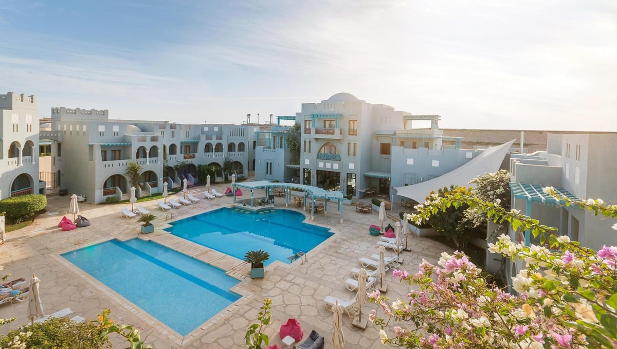 Fanadir Hotel El Gouna courtyard with two pools and surrounding buildings.