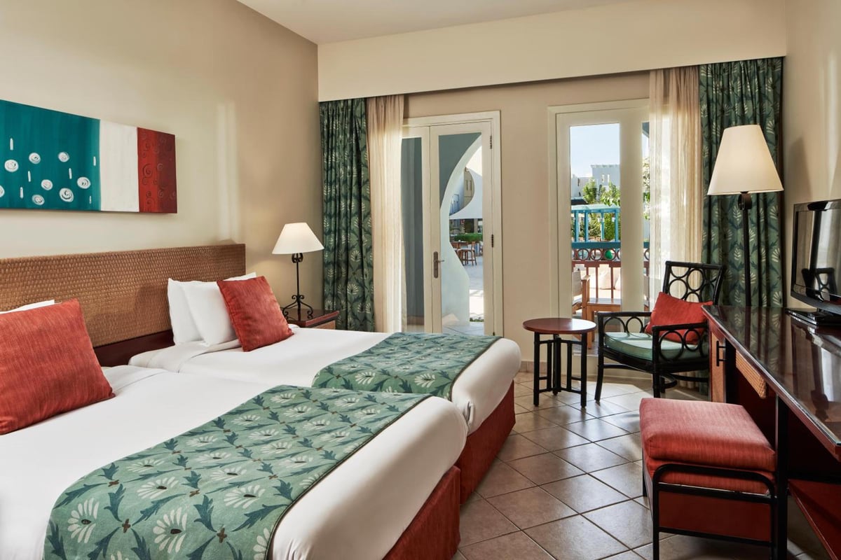 Fanadir Hotel El Gouna bedroom with twin beds and balcony doors.