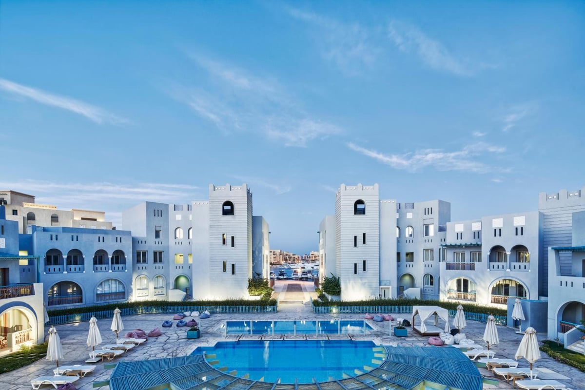 Fanadir Hotel El Gouna courtyard with a central pool and blue buildings.