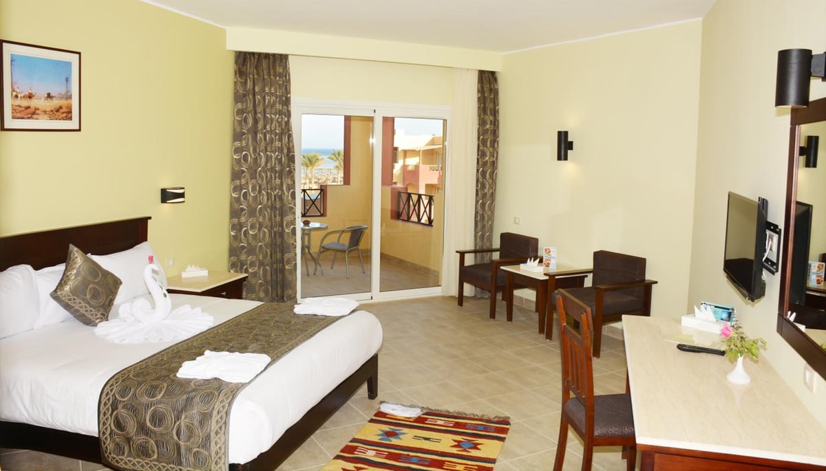 Casa Mare Resort Marsa Alam guest room with a bed and balcony.