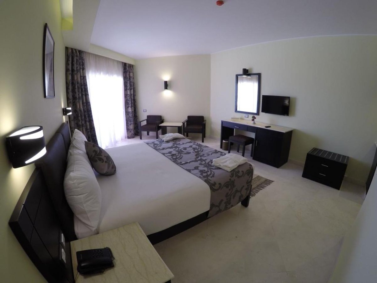 Casa Mare Resort Marsa Alam guest room with a bed and desk.
