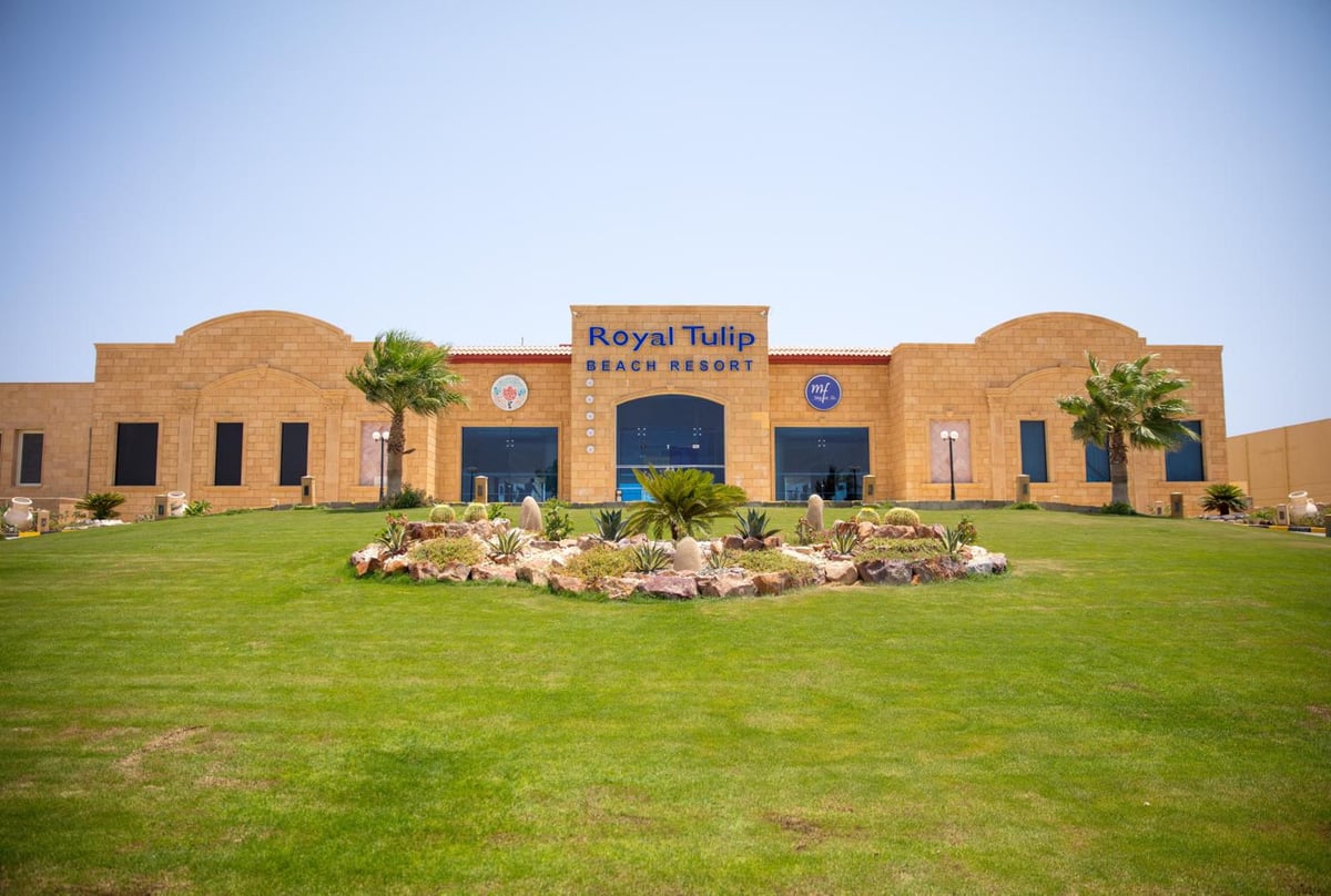 Casa Mare Resort Marsa Alam entrance with a brick facade and landscaped lawn.