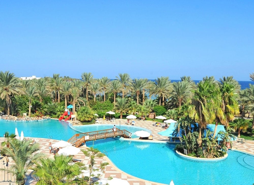 Brayka Bay Resort pool area with a waterslide and palm-covered island.