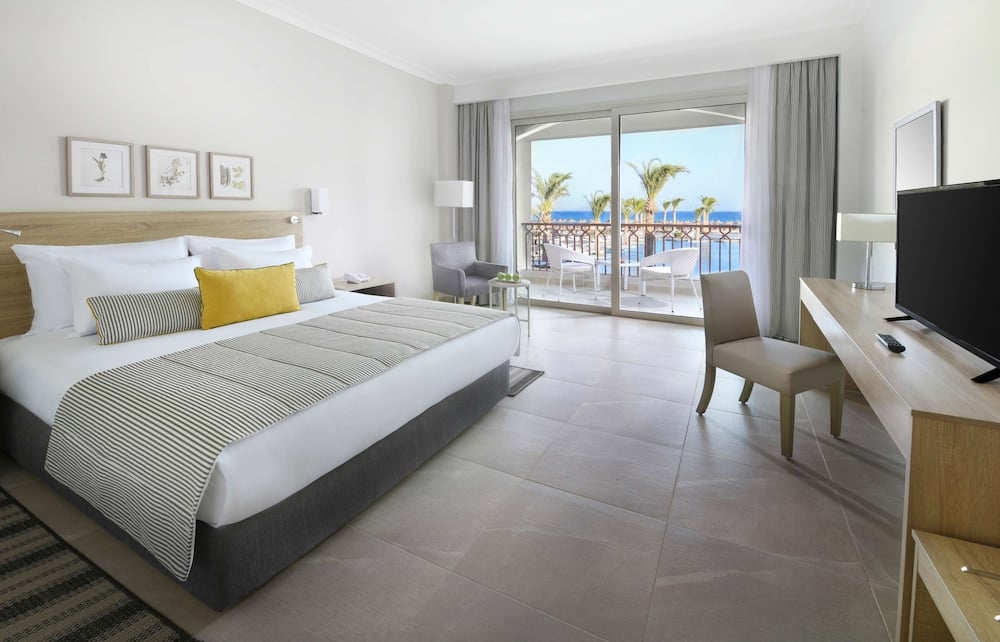 JAZ Costa Mares guest room with a large bed and balcony.