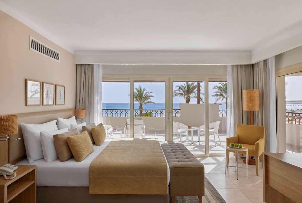 JAZ Costa Mares guest room with a bed and a balcony overlooking the sea.