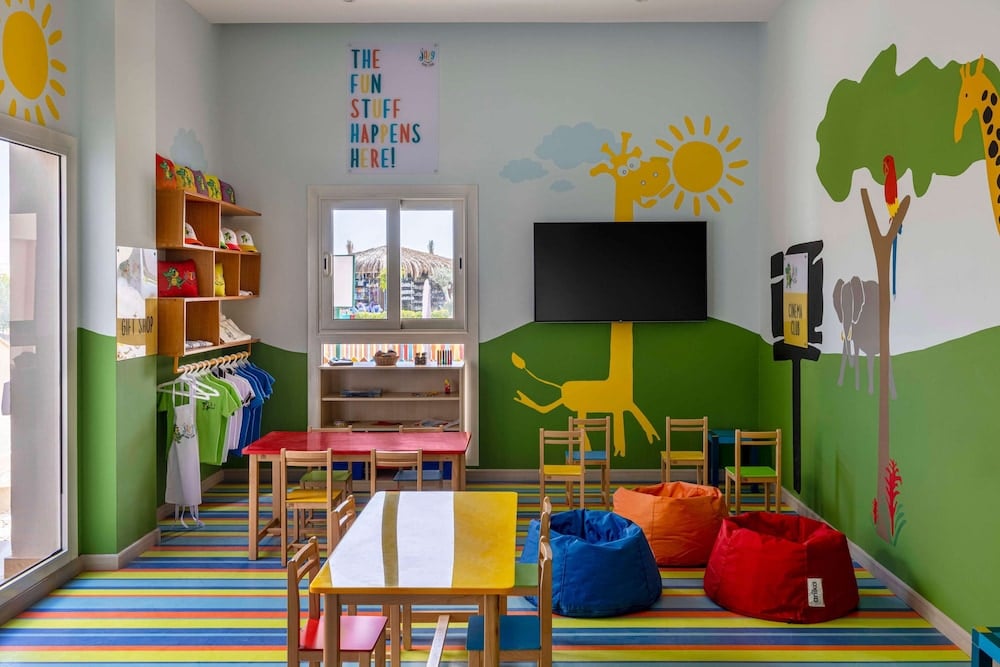 JAZ Costa Mares kids' playroom with a striped floor and animal murals.