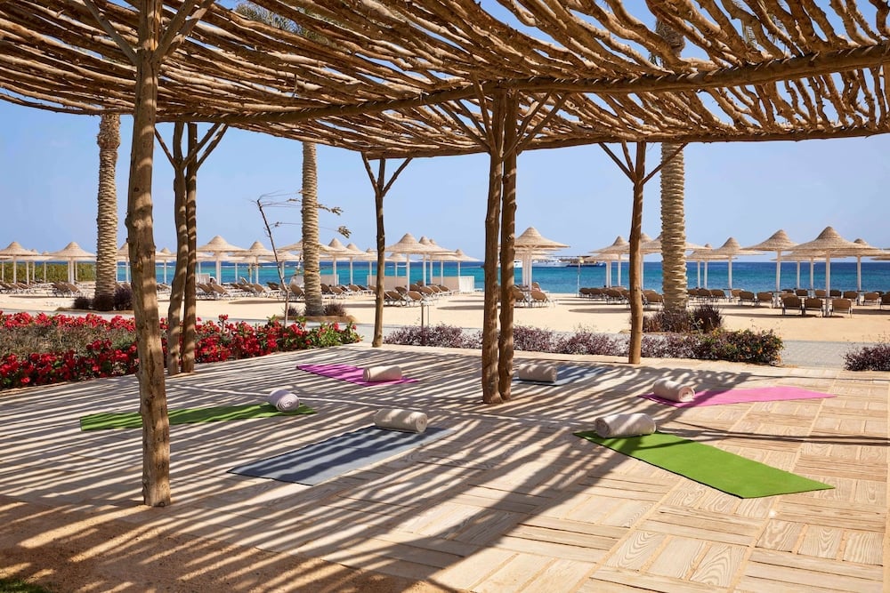 JAZ Costa Mares yoga area with a wooden pergola and exercise mats.