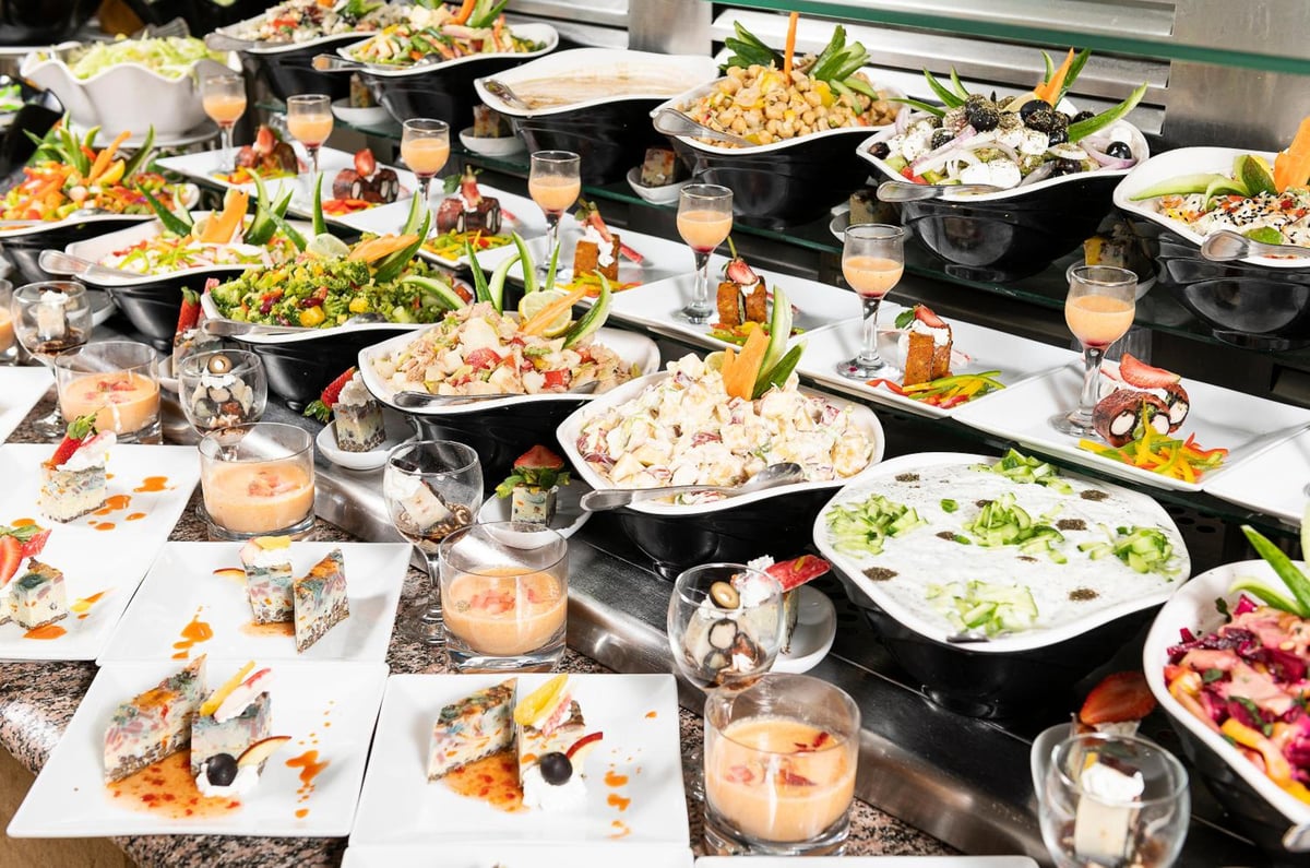 Three Corners Fayrouz Plaza Beach Resort buffet with assorted dishes and salad platters.