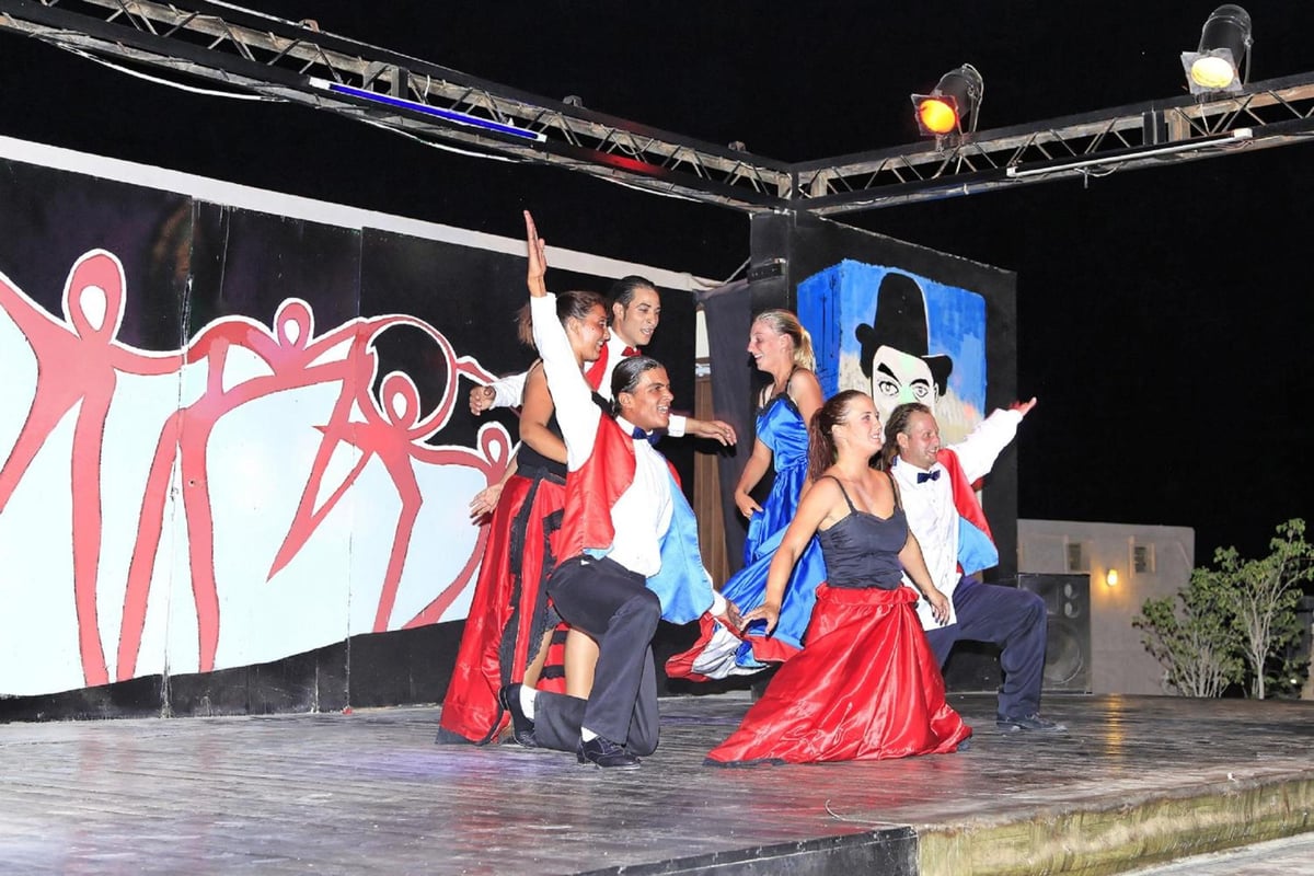 Three Corners Fayrouz Plaza Beach Resort stage with costumed performers and painted backdrop.