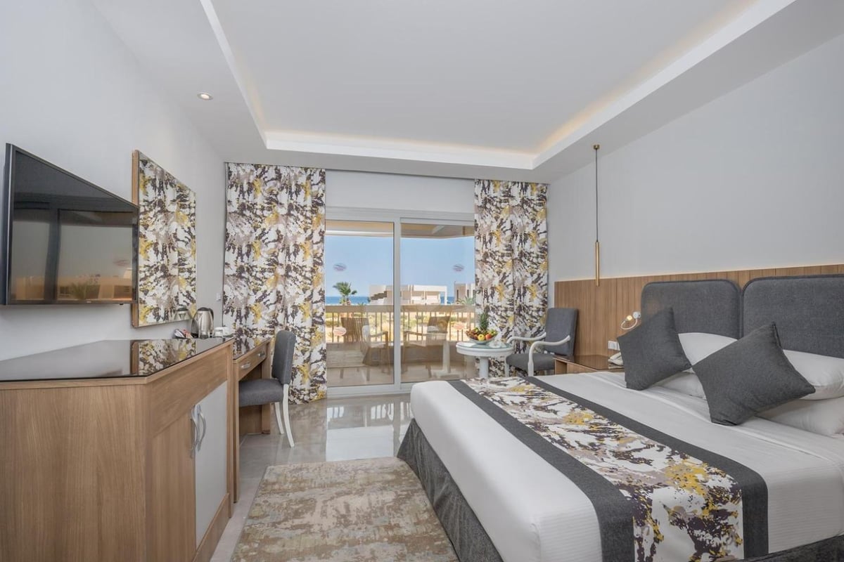 Long Beach Resort Hurghada guest room with twin beds and balcony doors.