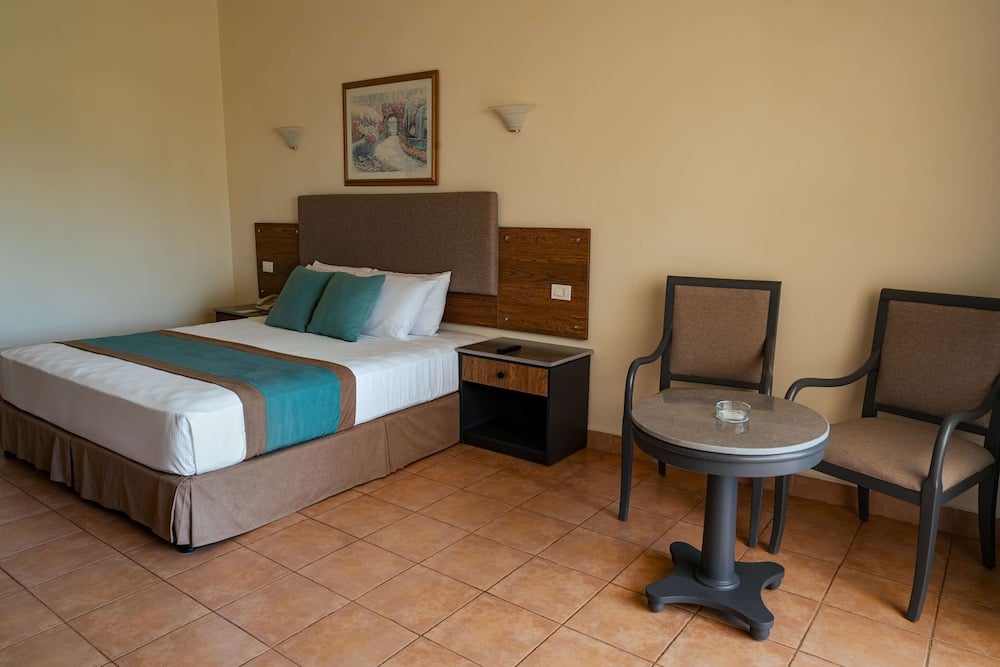 Long Beach Resort Hurghada guest room with double bed and seating area.
