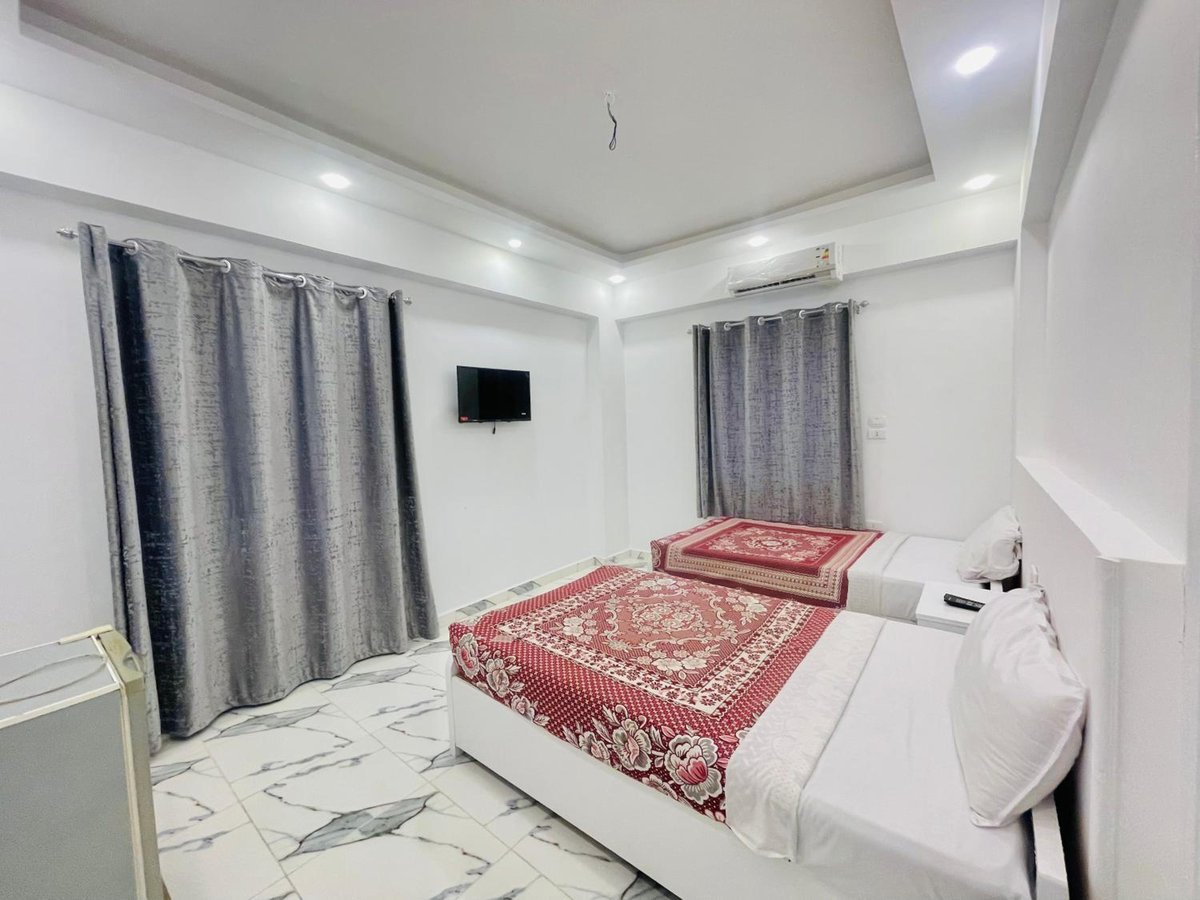 El Mesala Hotel Luxor twin bedroom with patterned bedspreads and grey curtains.