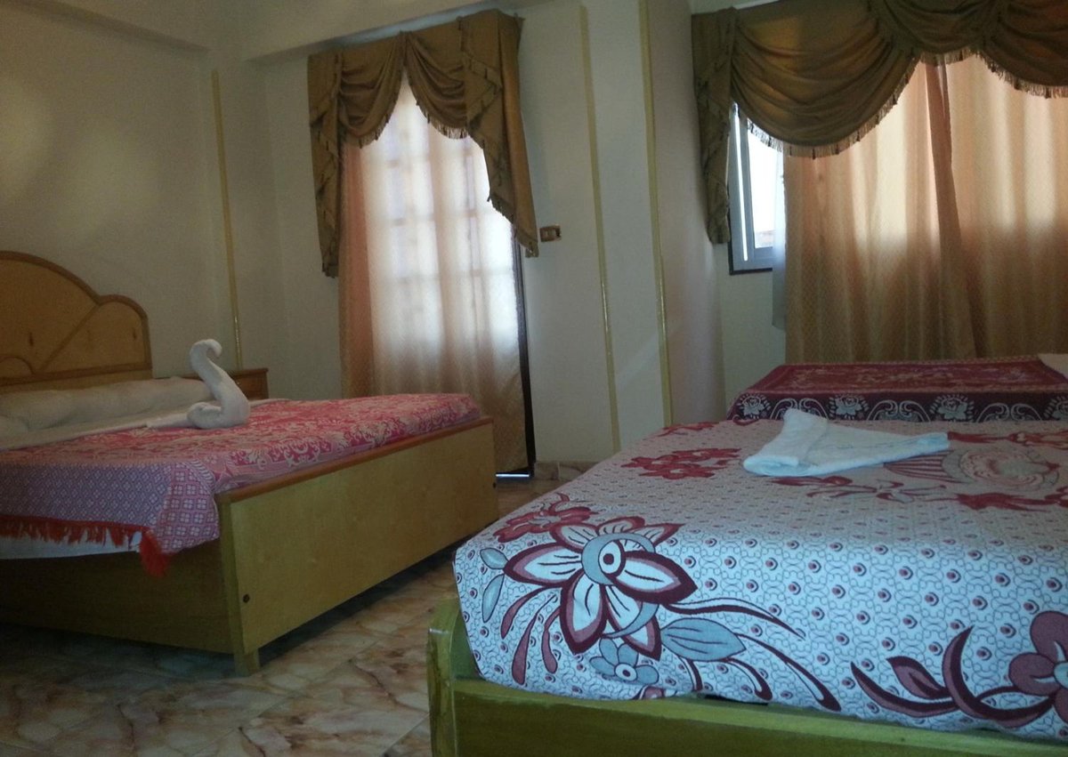 El Mesala Hotel Luxor twin bedroom with two beds and curtained windows.