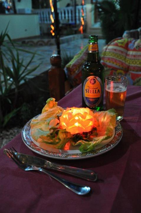 El Mesala Hotel Luxor patio dining area with a plated meal and courtyard plants.